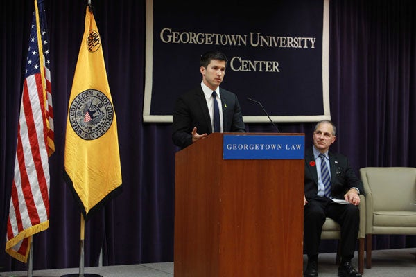 Retired Lt. Brandon Stone (L’15), a former U.S. Navy SEAL, speaks from a podium at the Law Center.