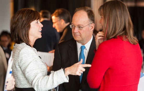 Georgetown President John J. DeGioia talks with event participants following the event.