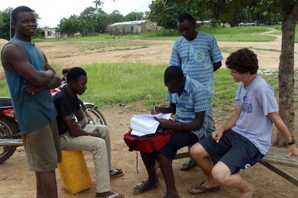 Thomas Brooke joins a pair of field workers on a census project in Ghana during an interview outside