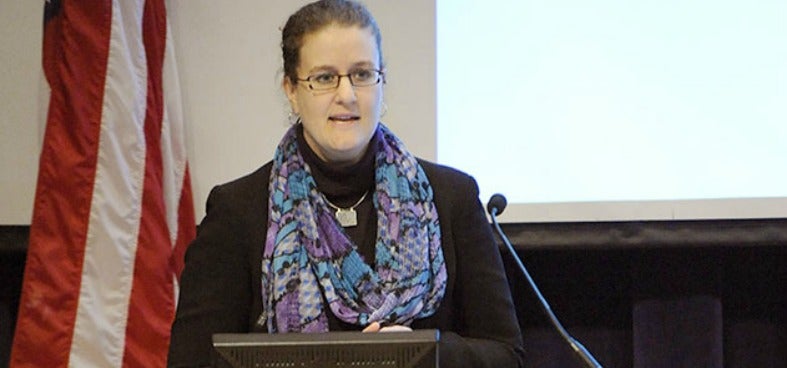 Elizabeth Cameron speaks at a podium with microphone