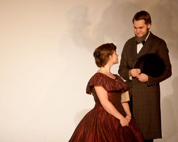 Brendan Quinn, as President Lincoln, looks into the eyes of Mary Todd Lincoln, played by Vivian Cook on stage in DPAC.