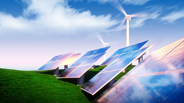 solar panels with windmill in background