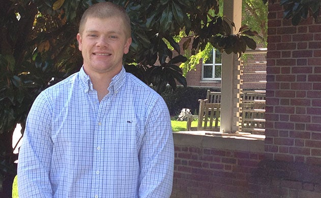 Dressed in a light blue button down shirt, Freeman Condon smiles for the camera. 