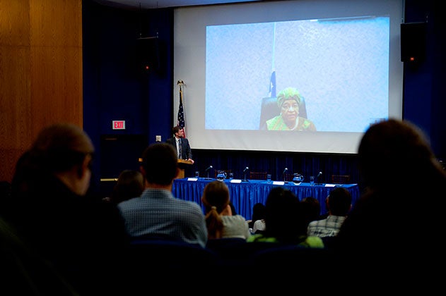 Steven Radelet speaks with President Sirleaf via projector at the Ebola Symposium 2014.