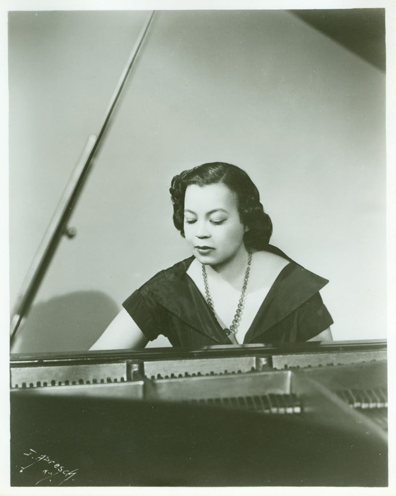 A black and white photo of Margaret Bonds at the piano. 