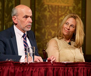 Jerry Seib and Melinda Henneberger sit behind a table on Gaston Hall's stage.