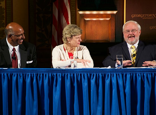 John Carr speaks as part of a panel onstage in Gaston Hall.