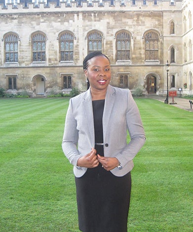 Carol Ibe stands in front of campuc building.