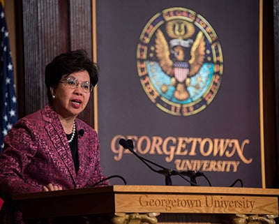 Margaret Chan speaks from a podium onstage in Gaston Hall.