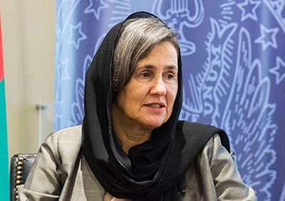 Rula Ghani sitting in chair with Georgetown seal behind her