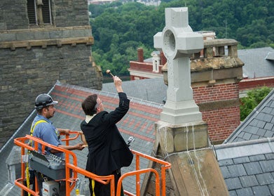 Rev. Kevin O'Brien blesses the Healy crosses 100 feet in the air.