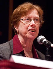 Susan Martin speaks into a microphone.