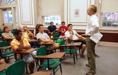 Bryan McCann stands in front of classroom talking to students