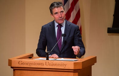 NATO Secretary General Anders Fogh Rasmussen speaks at a podium after receiving the Hillary Rodham Clinton Award for Advancing Women in Peace and Security.