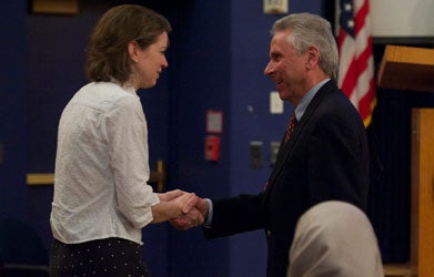 Heidi Elmendorf shakes hands with Allan Angerio