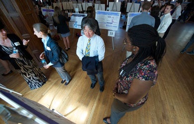 Martin Iguchi looks at Vivian Choma's research in Copley Formal Lounge