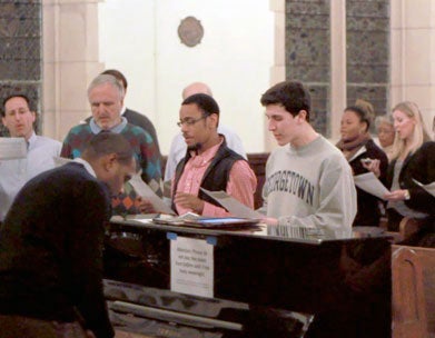 Nolan Williams plays the piano while choir sings