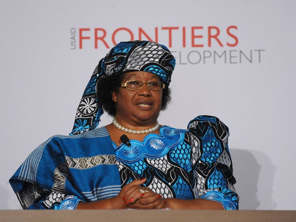 Joyce Banda smiles while sitting and speaking on a panel