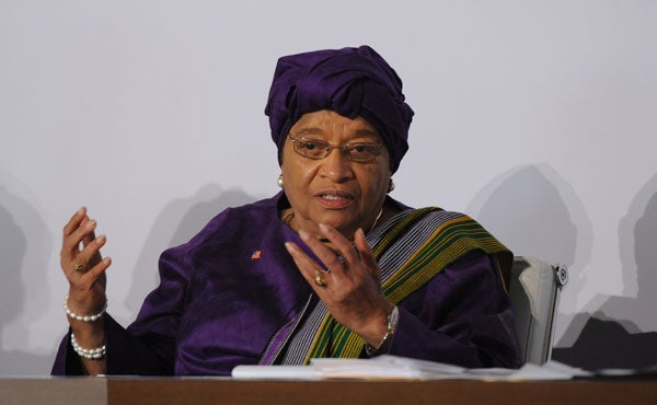 Ellen Johnson Sirleaf speaks on a panel while seated in front of a backdrop