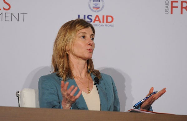 Nancy Lindborg speaks while seated in front of a USAID backdrop