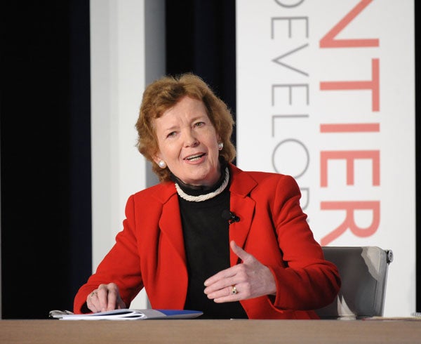 Mary Robinson speaks on a panel while seated in front of a backdrop