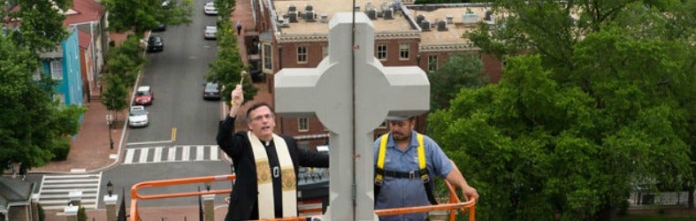 Rev. Kevin O’Brien blesses the Healy crosses 100 feet in the air.