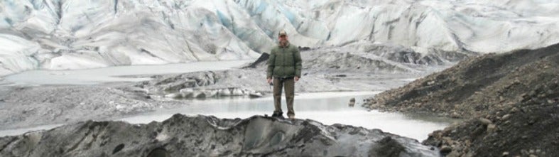 Doug Howard stands on a glacier.