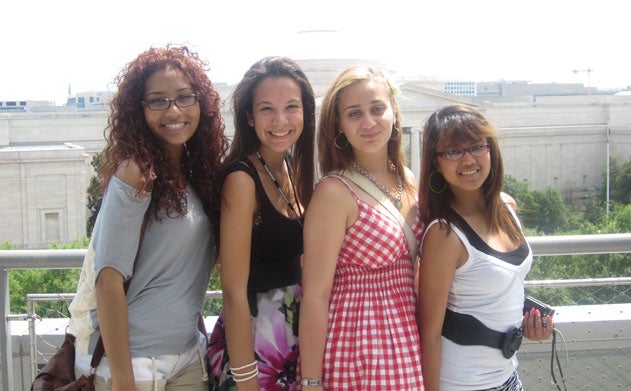 Cristo Rey and KIPP students pose for a photo on a rooftop 