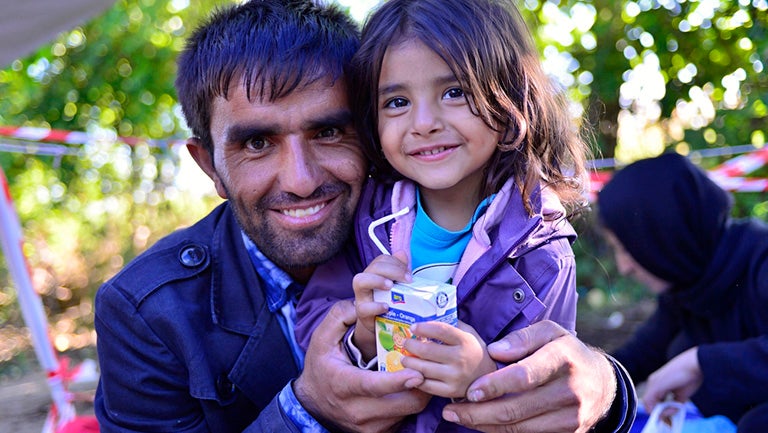 Immigrant father holding young child