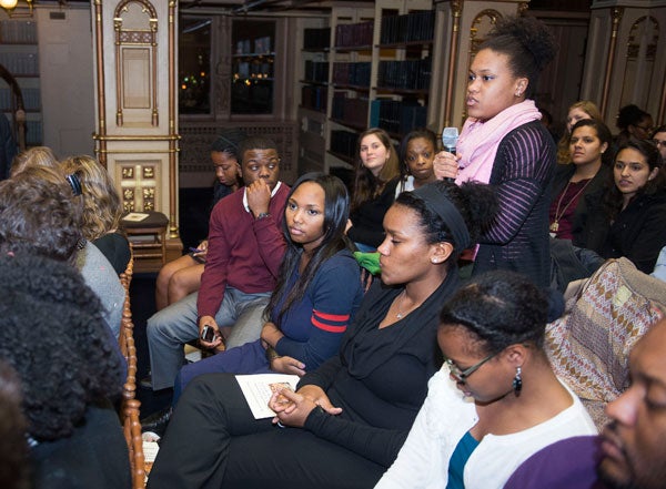 A student stands to ask a question in Riggs Library