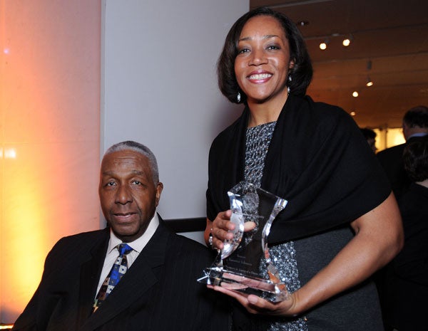 Lecester Johnson stands with award next to John Thompson Jr.