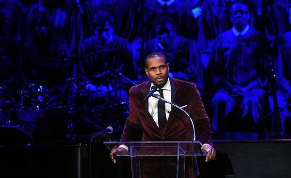 Nolan Williams speaks at the podium on stage at the Kennedy Center