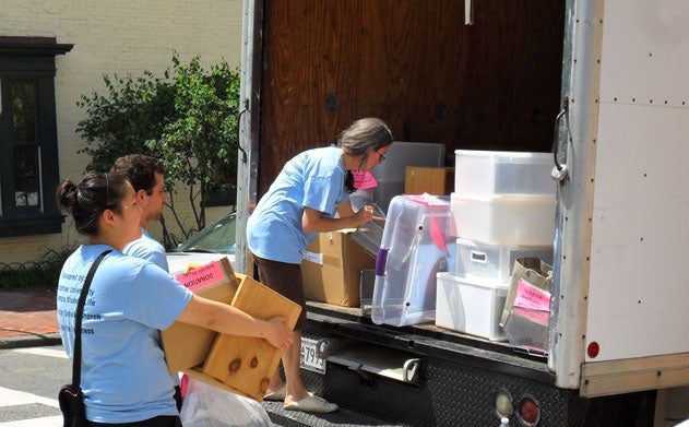 Student volunteers load goods in a 26-foot truck during the move-out drive.