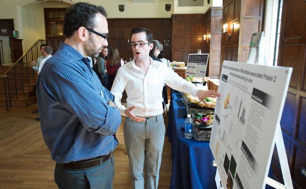 Ryan Bellmore presents poster to Pablo Irusta in Copley Formal Lounge