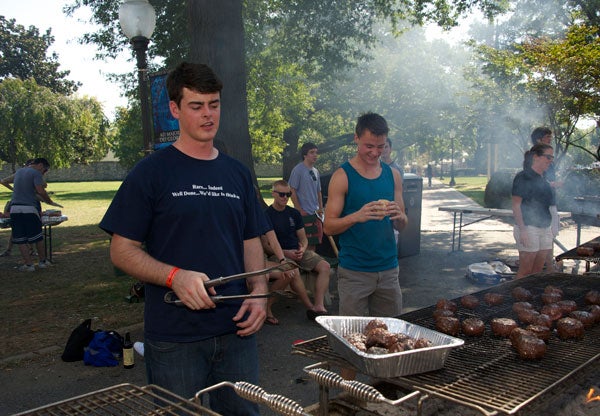 Christopher Griffin (B'13), president of Georgetown University Grilling Society (GUGS), cooks up some burgers for the picnic.