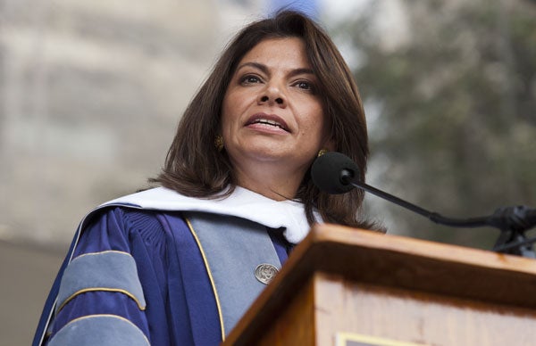 Costa Rican President Laura Chinchilla (G’89) speaks at the podium to an audience of graduates.