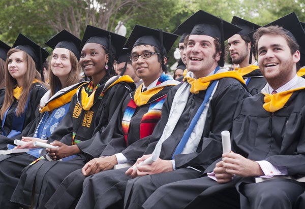 Seated graduates smile after receiving the degree of bachelor of science in foreign affairs.