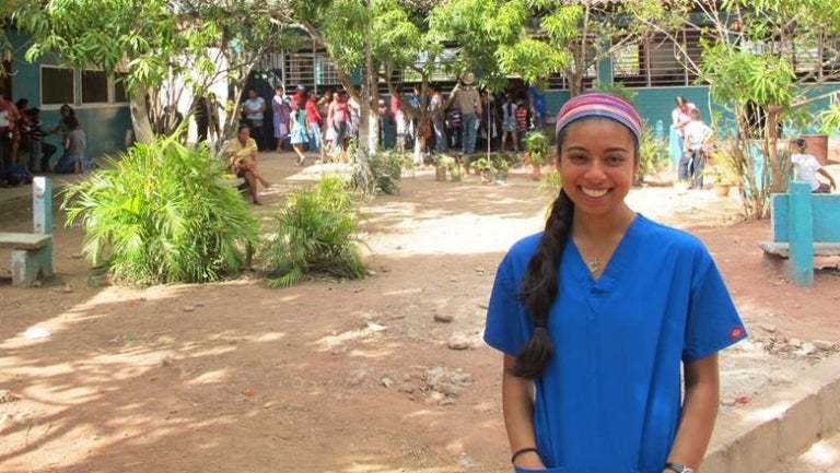 A student poses for the camera on a trip abroad