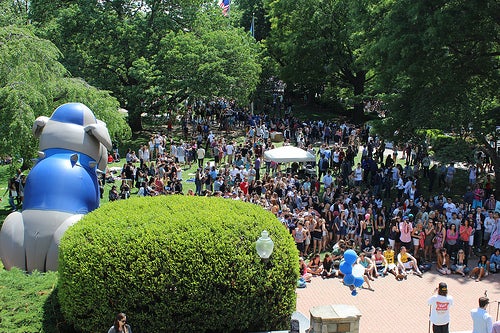 Students gather on the front lawn of campus at an event