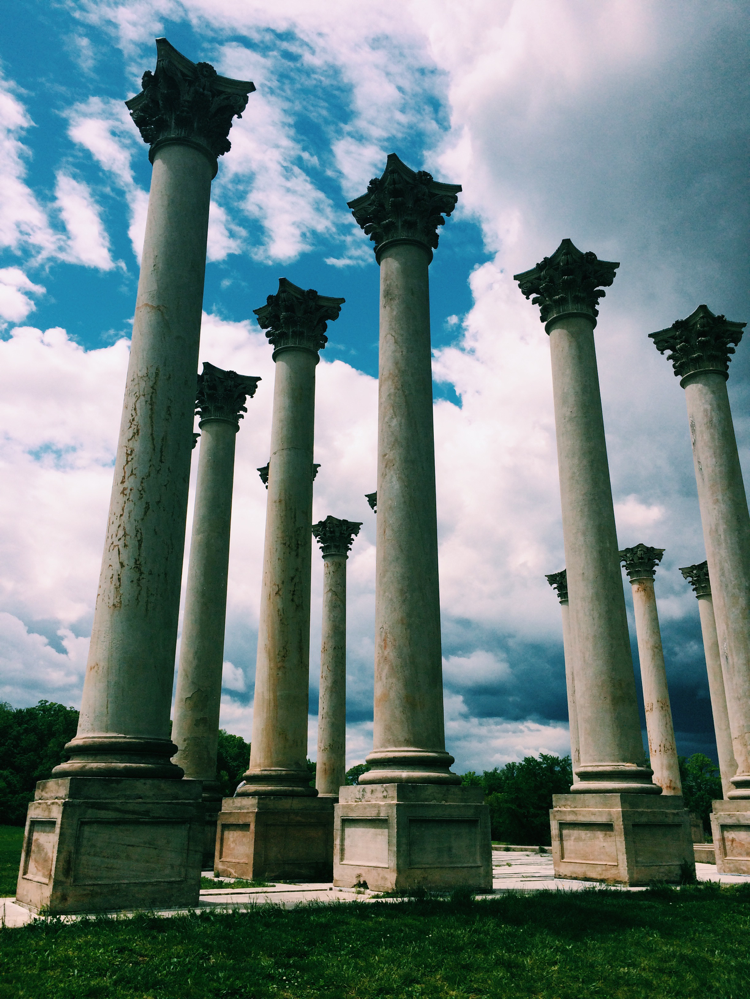 Columns rise above the ground on a sunny day at the Arboretum