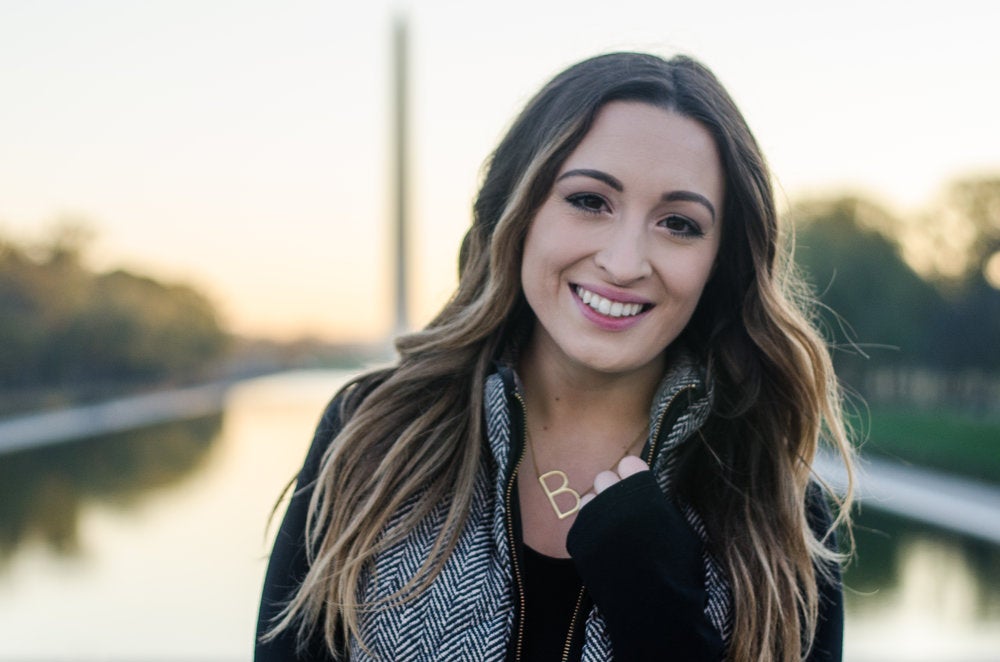 Bella Gerard smiles for the camera in front of the Washington Monument.